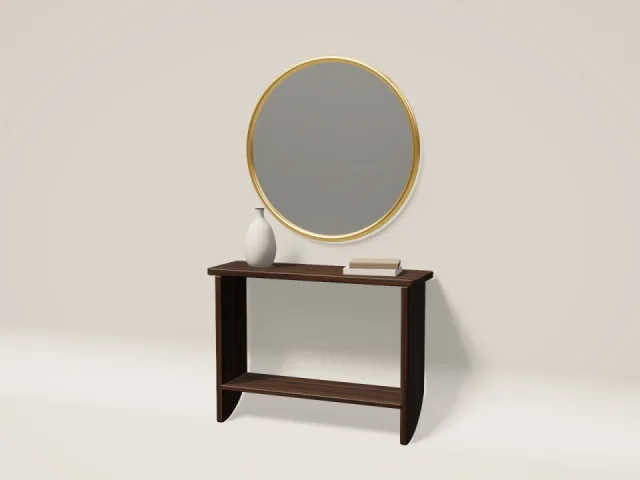 Round wall mirror with a polished brass frame above a walnut console