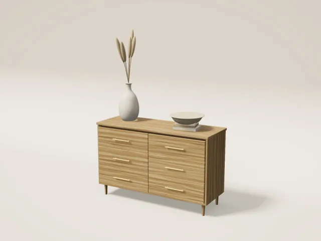 Oak six-drawer dresser with brass handles, styled with a vase and books